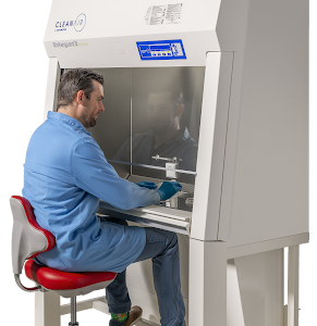 Lab technician working on a CleanAir by Baker Biovanguard Class II biosafety cabinet in a microbiology lab