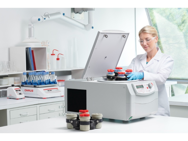 Laboratory scientist loading a high speed centrifuge with 50 ml tubes